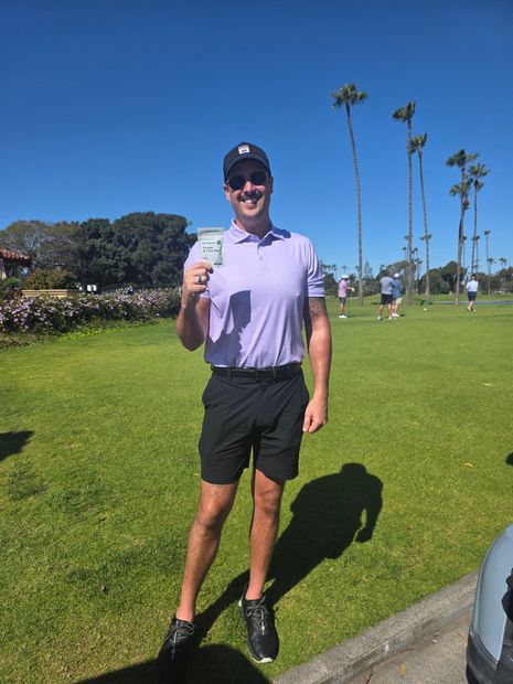 Golfer smiling with birdiegum pack