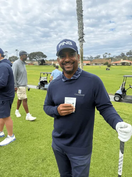 Golfer holding birdiegum on the course