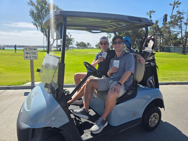 Two golfers in a cart