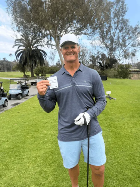 Golfer showing birdiegum pack